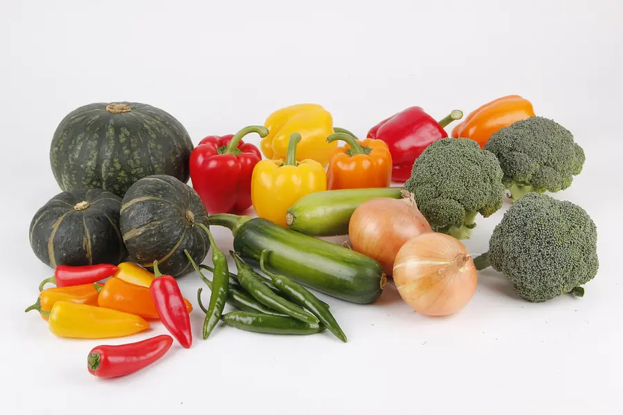 Bell peppers, broccoli, zucchini and squash on a white background