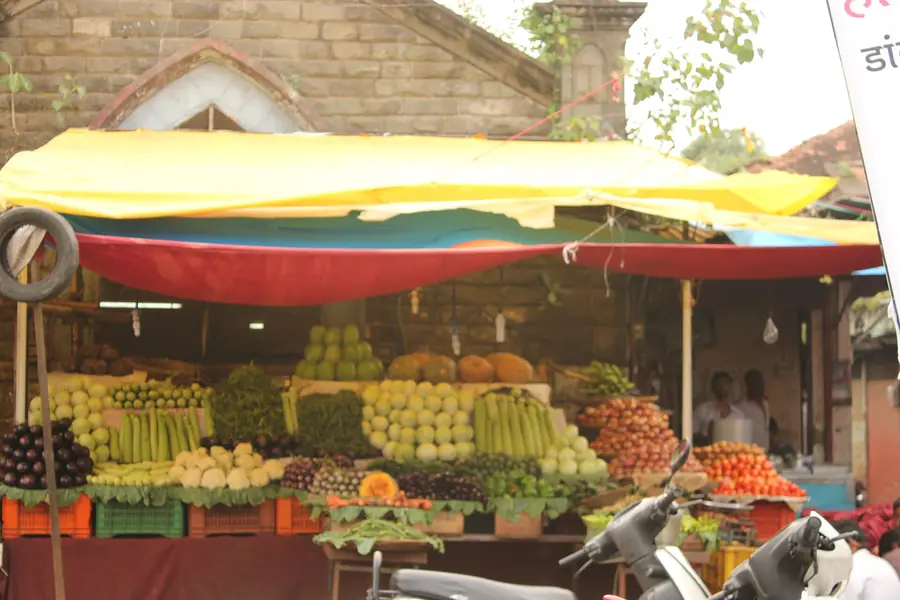 Fruit stall stacked with apples, oranges and bananas